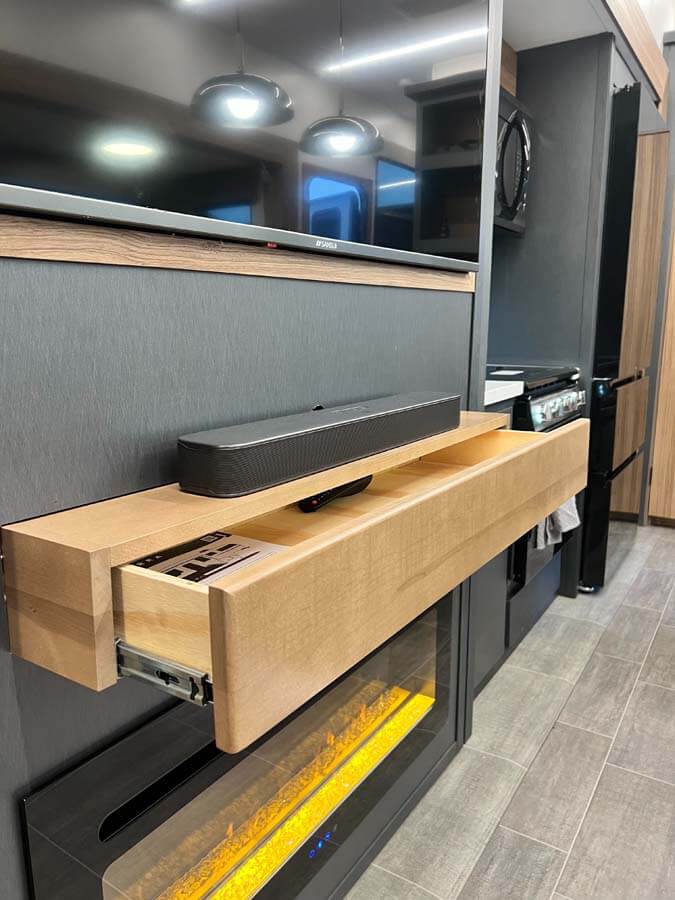 A drawer below the soundbar gives a natural place for remotes